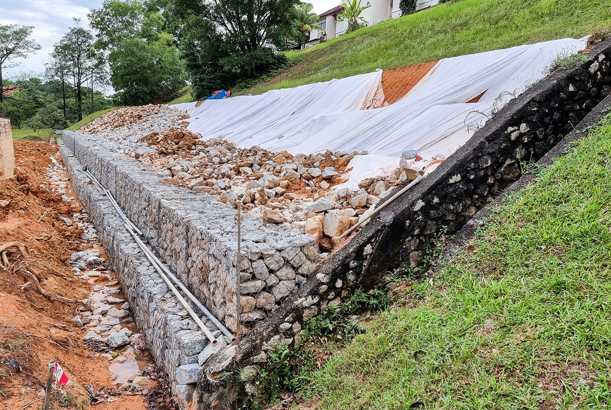 Erosion control with stone and tarp